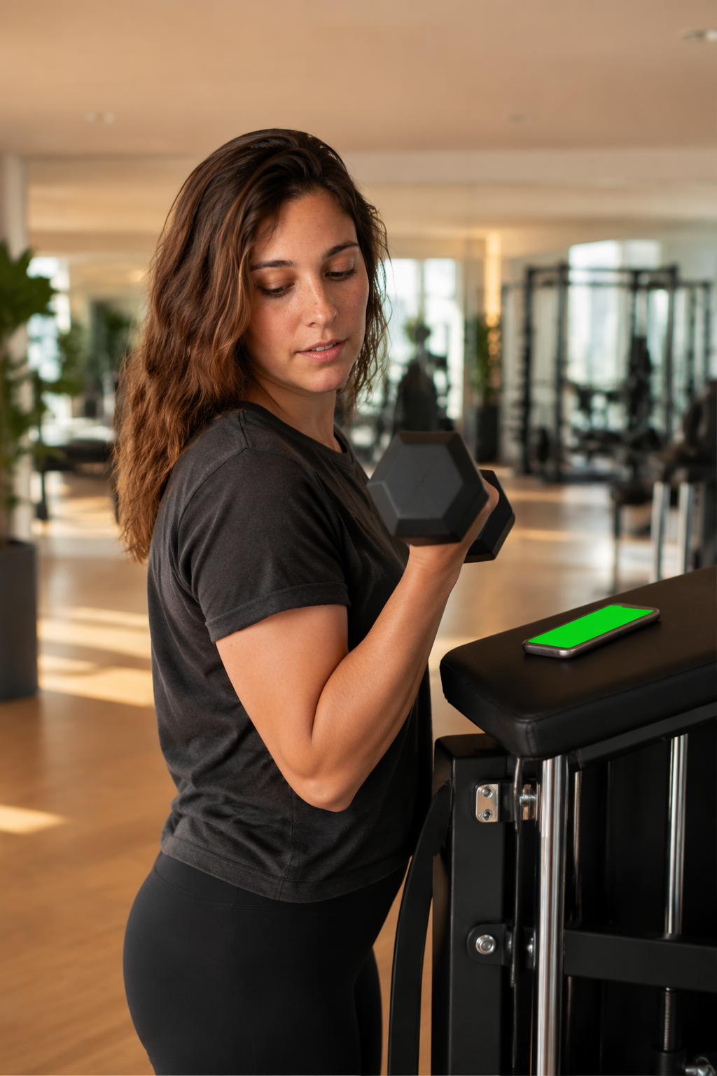 Hands full at the gym, she calls out a Siri log without breaking stride.